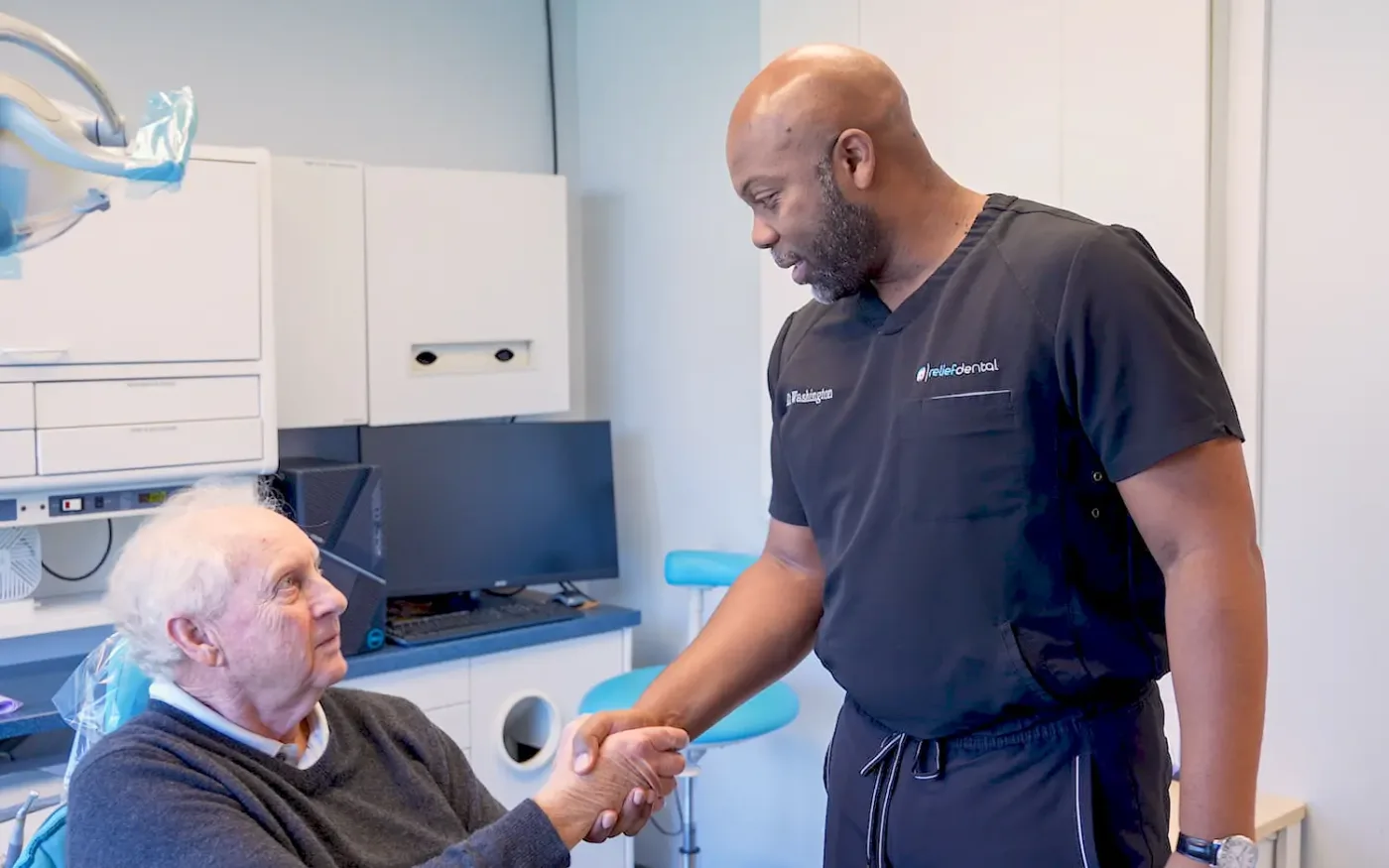 Dr. Melvin Washington greeting a patient at Relief Dental in Tucker, GA